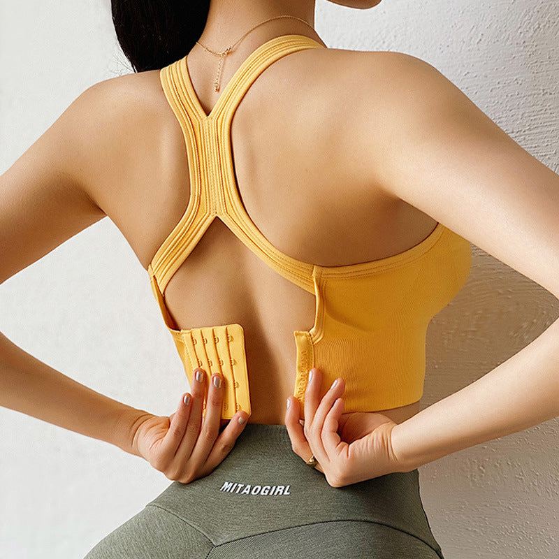 Basic supportive womens sports bra in lemon yellow with smooth nylon fabric and light impact support