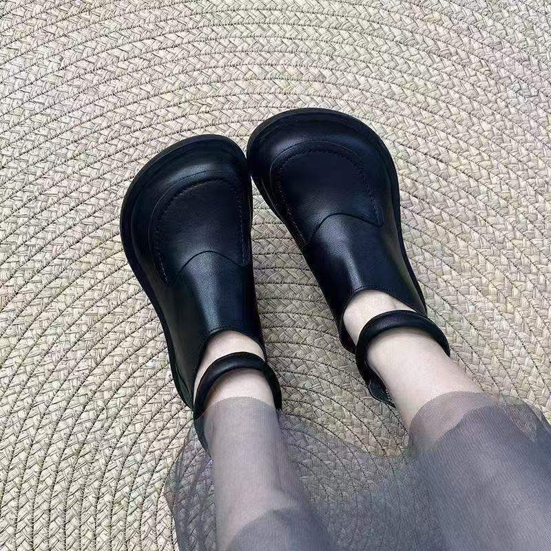 Black leather shoe with cross-laced wrap closure for comfortable daily walking
