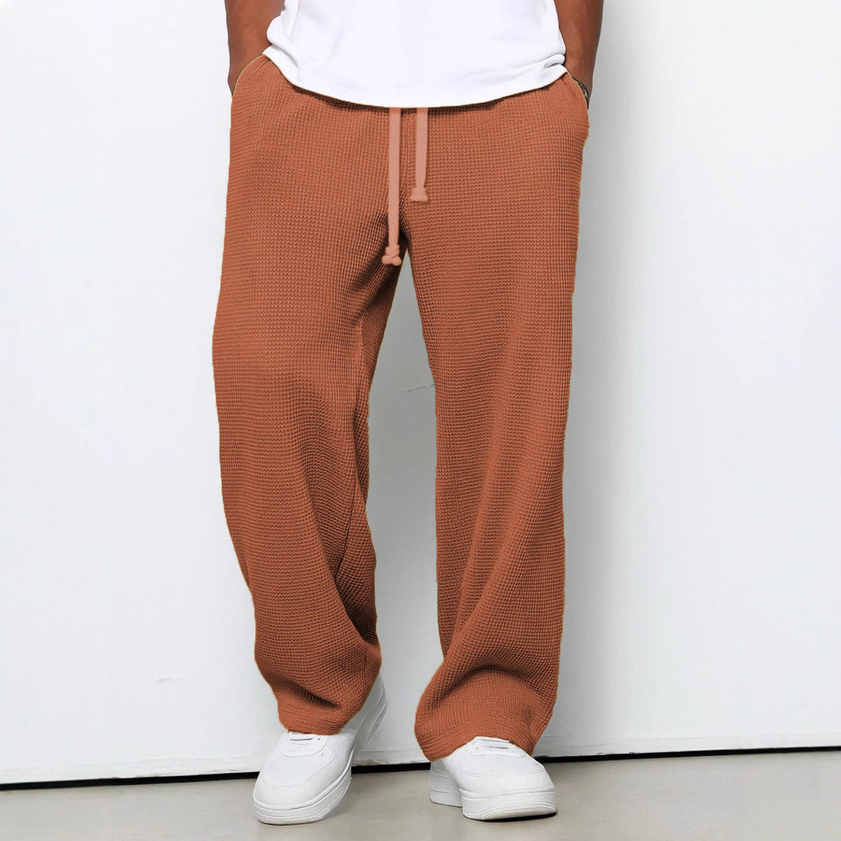 Men wearing colorful waffle knit sweatpants with "I Missed The Summer So Crazy, Sorry People" graphic and relaxed fit in casual setting