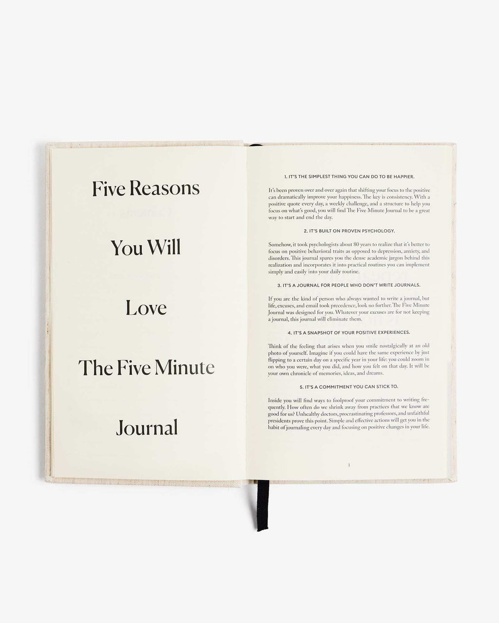 The Five Minute Journal original linen cover with open pages and guided prompts for morning and evening routines