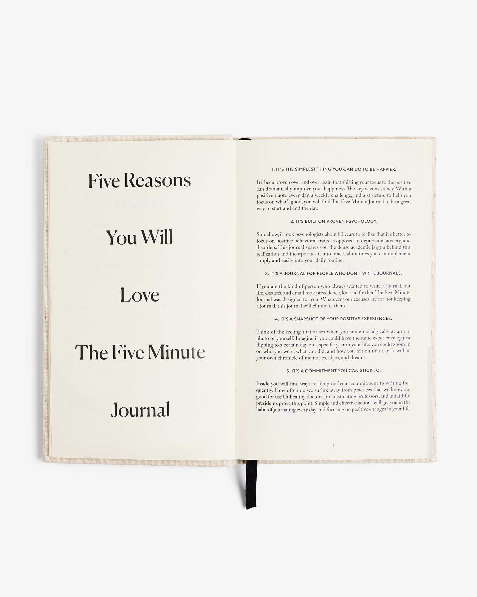 The Five Minute Journal original linen cover with open pages and guided prompts for morning and evening routines