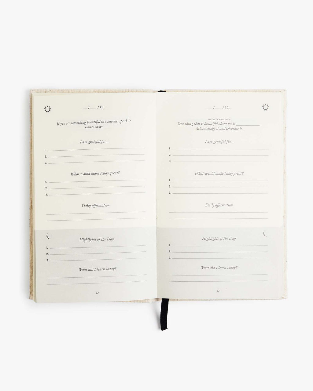 The Five Minute Journal with textured linen cover and lay-flat binding open on a table