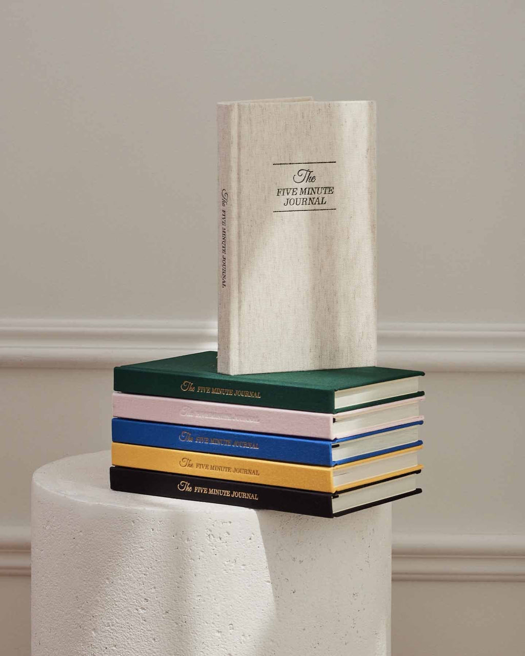The Five Minute Journal Original Linen cover with lay-flat binding and structured guided prompts visible on open pages