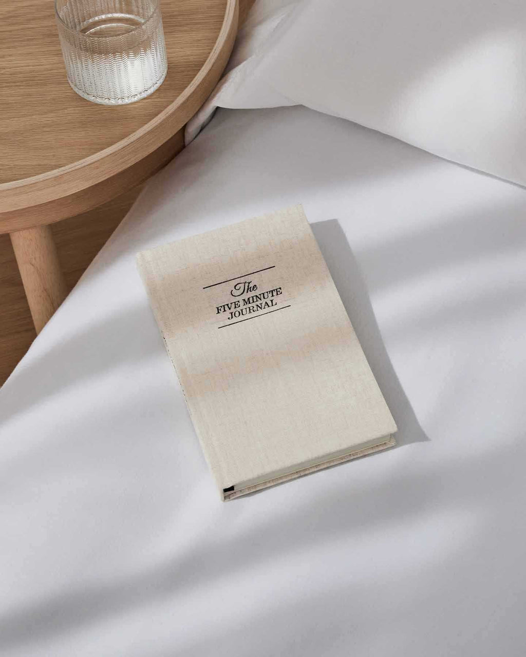 The Five Minute Journal with linen cover and lay-flat binding opened on a table