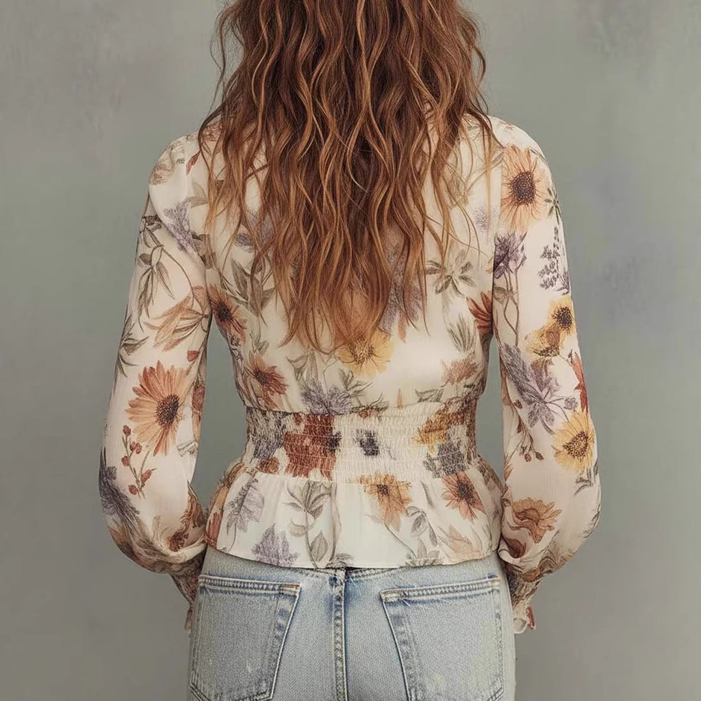Woman wearing a slim-fit polyester-knit pullover with a multi-hued floral motif and hardware-free neckline
