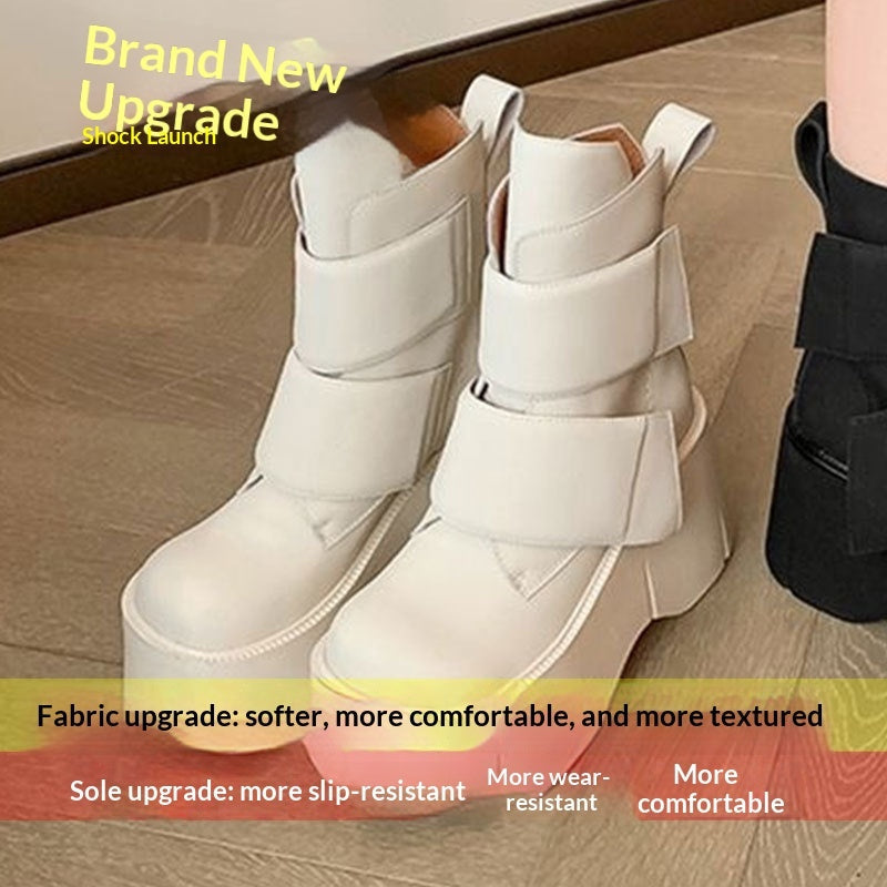 Black mid-calf platform boots with rounded toe and velcro closure styled with wide-leg pants