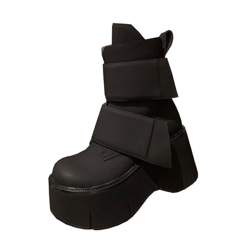 Mid-calf platform boots with rounded toe and velcro closure styled with wide-leg pants