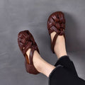 Satin feel unique woven sandals with closed toe, back heel strap, lightweight PVC upper, and flexible TPU outsole in dark brown, green, and red colors.