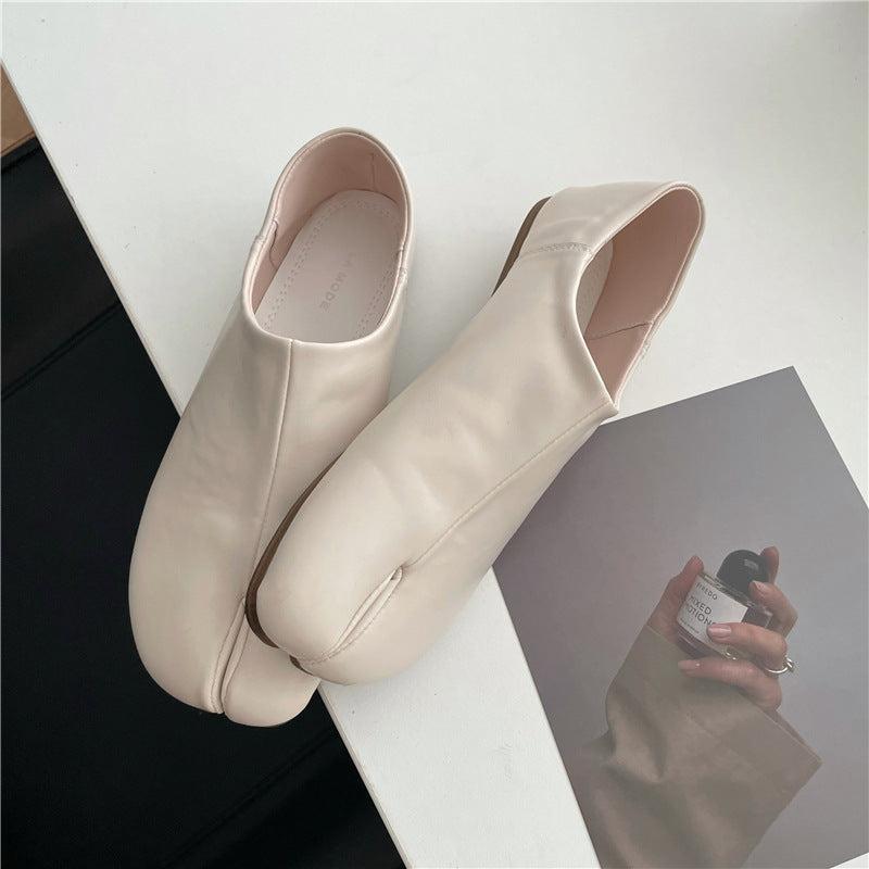 Black split-toe Tabi shoe flats with a flexible microfiber upper and zero-drop rubber sole