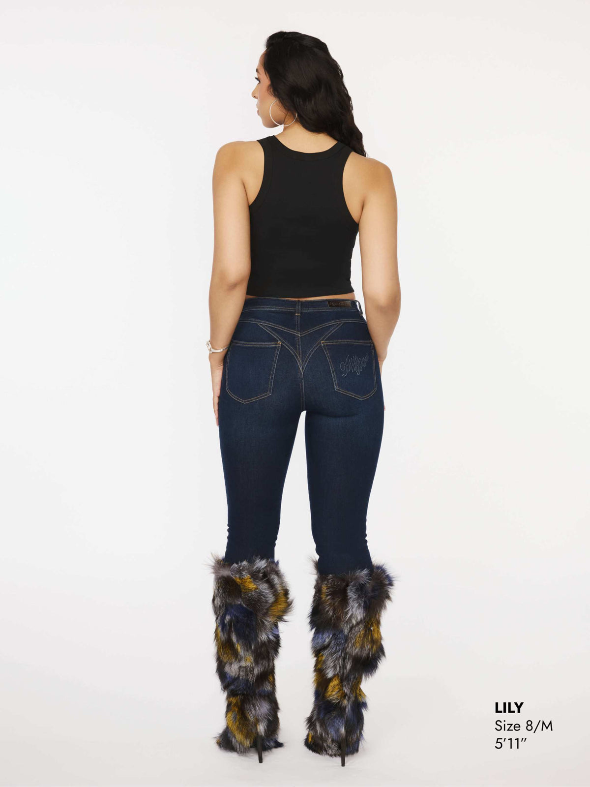 Close-up of Apple Bottoms brand thong denim jeans showing stitched posterior detail and tapered ankle cut