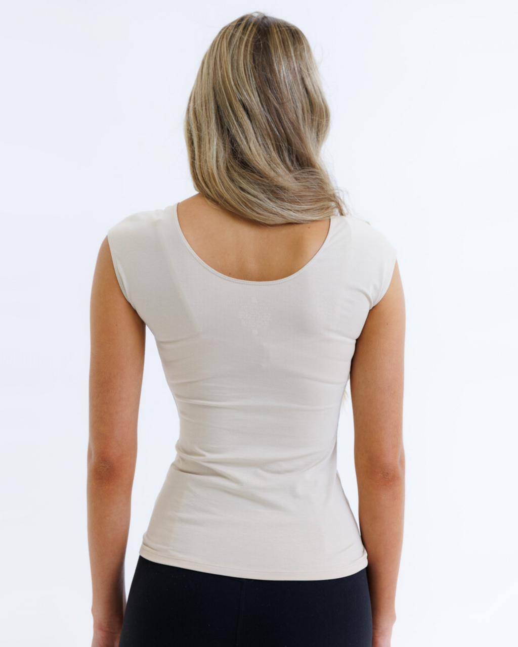 Breathable essential tee with shortened torso and cap sleeves for a sleek silhouette under layers