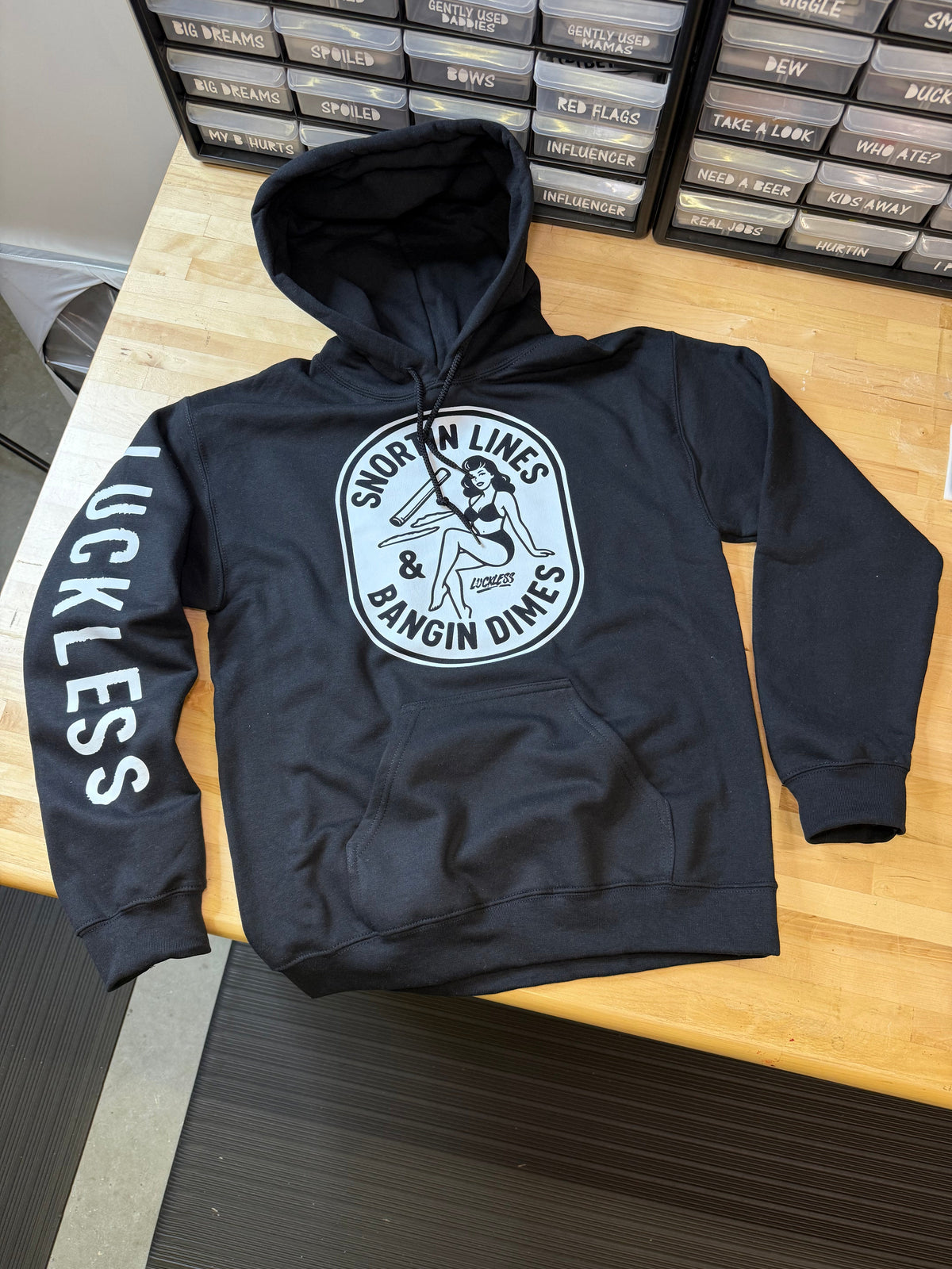 Black men's Lines and Dimes Hoodie with vintage graphic and Luckless branding, streetwear style