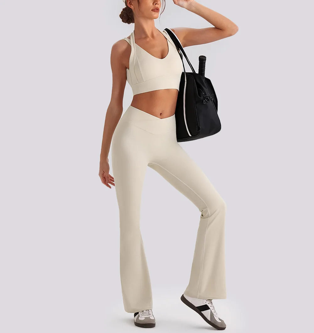 Women's yoga exercise set with backless sports tank top and high waist wide leg pants for gym and workout