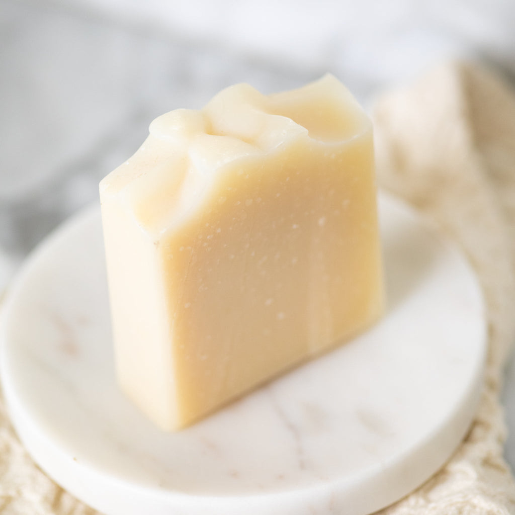 Pure + Simple Skin Kit with fragrance-free tallow body butter in amber jar and probiotic goat milk soap bar for sensitive skin