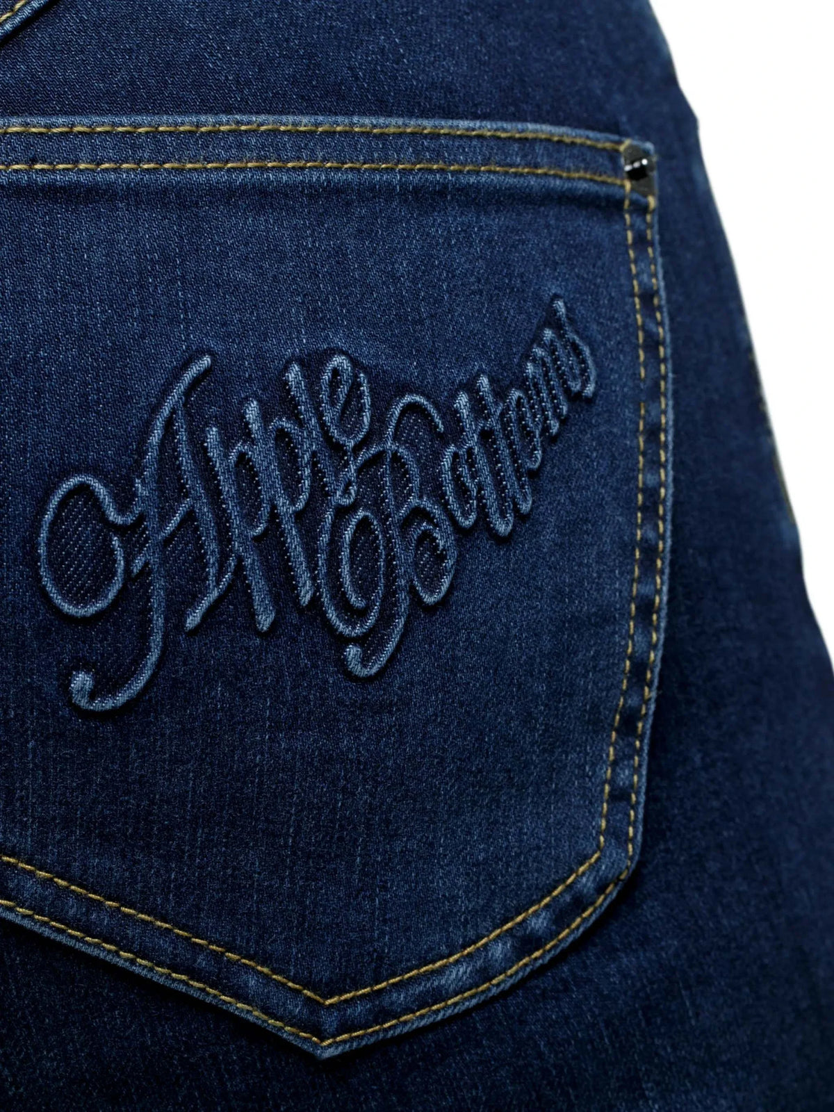 Close-up of Apple Bottoms brand thong denim jeans stitching and posterior detail