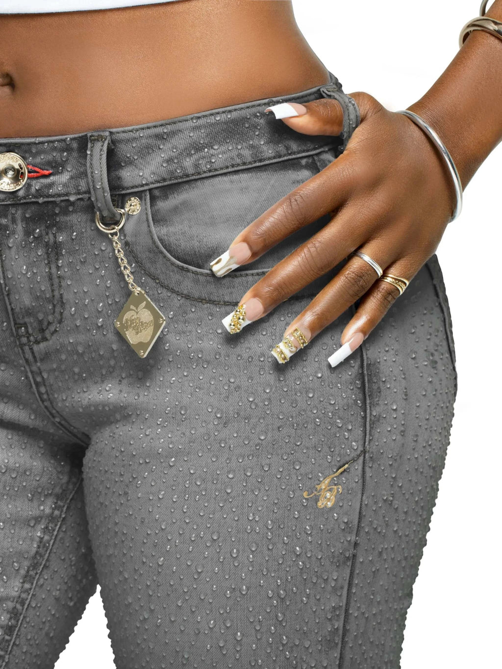 Model wearing Apple Bottoms by Nelly varsity jacket paired with black Rain on Me Jeans featuring 3D raindrop print and rhinestone accents