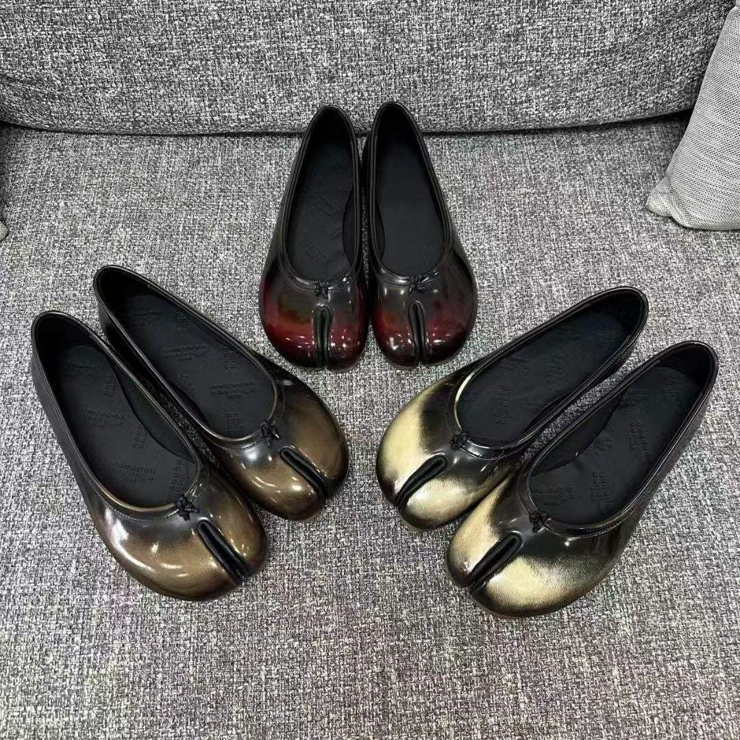 gold and black vegan leather tabi shoes with split-toe design and zero-heel rubber sole