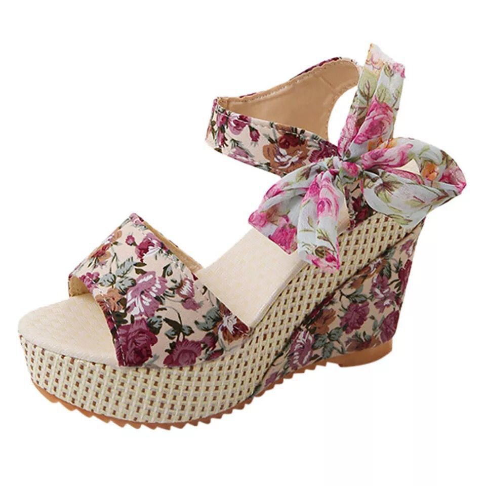 Gorgeous pair of espadrilles with cross-strap and embroidered floral design on sun-warmed tile