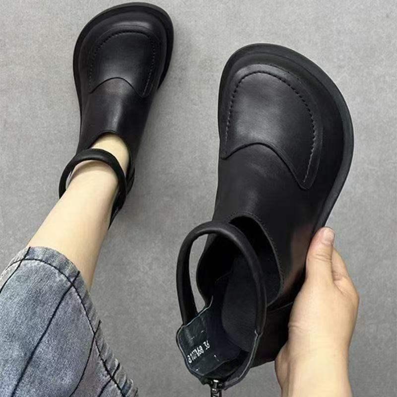 Black leather shoe with cross-laced wrap closure and textured rubber sole for comfortable daily walking