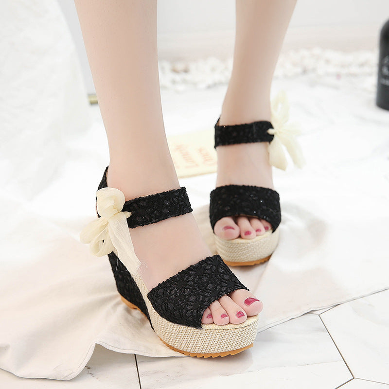 Gorgeous pair of espadrilles with padded faux-leather footbed, satin ribbons, tiny blooms, and narrow wedge heel