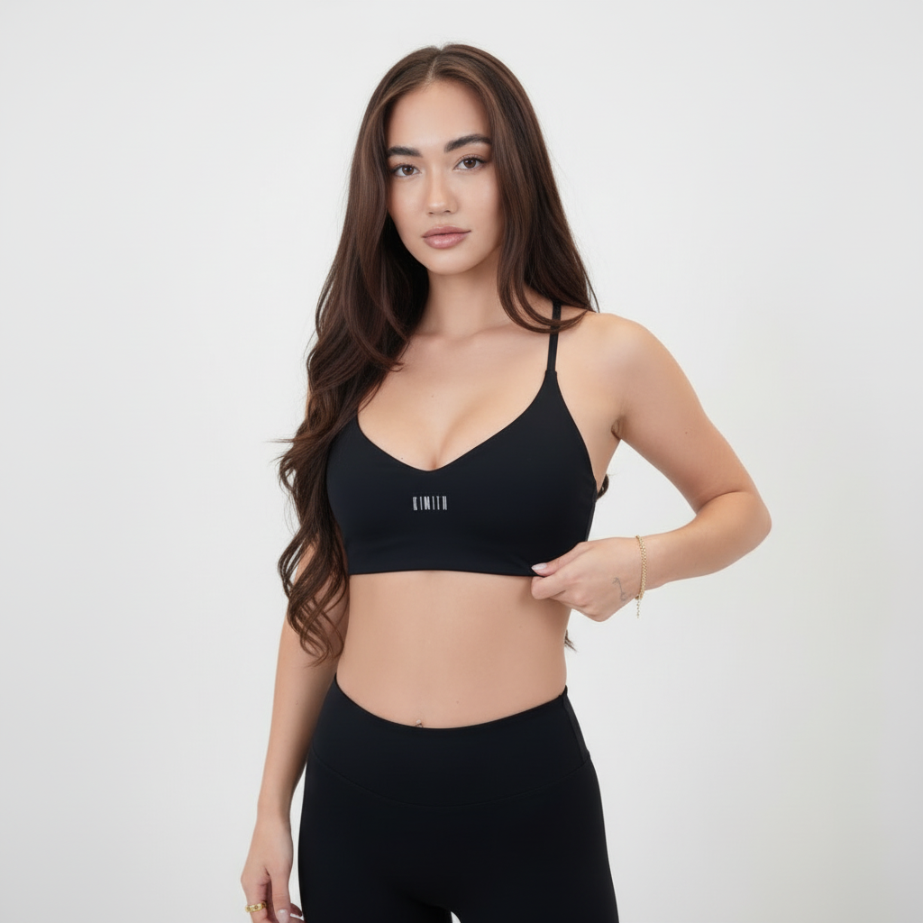 Luxury Black Sports Bra with slim straps and scoop neckline, made from smooth nylon-spandex blend with white logo detail